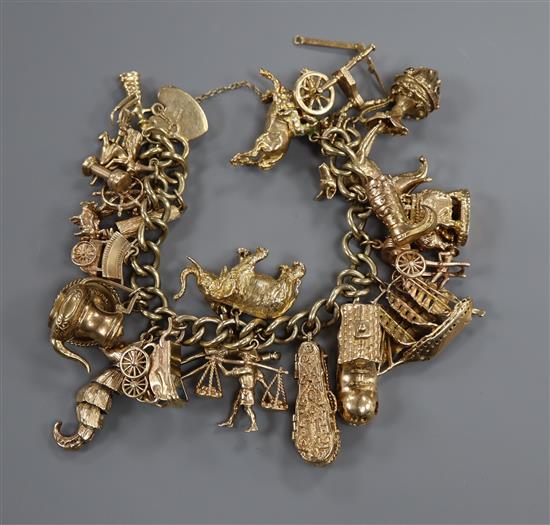 A 9ct gold curblink charm bracelet hung with twenty two assorted charms and a heart padlock